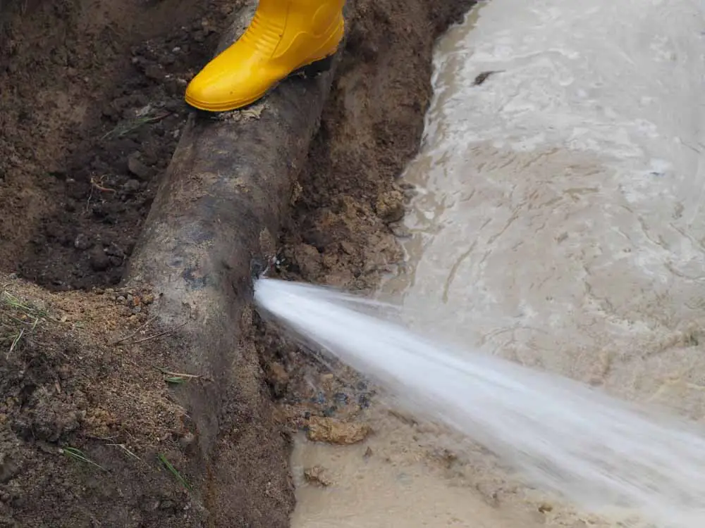 water gushing from a burst pipe