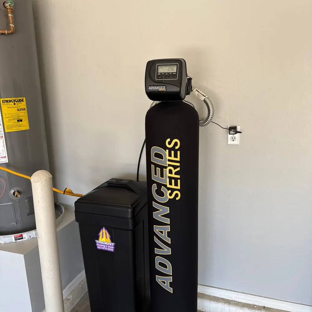 Professional installation of a whole home water softener system in a Phoenix garage.