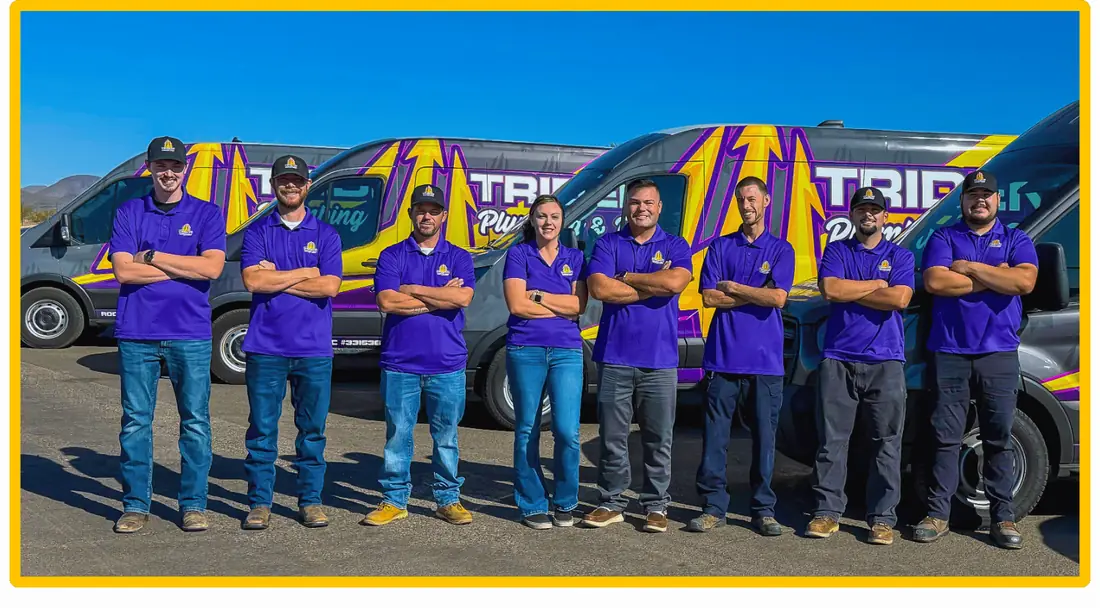 Trident Plumbing & Drain Team Photo posing infront of work trucks