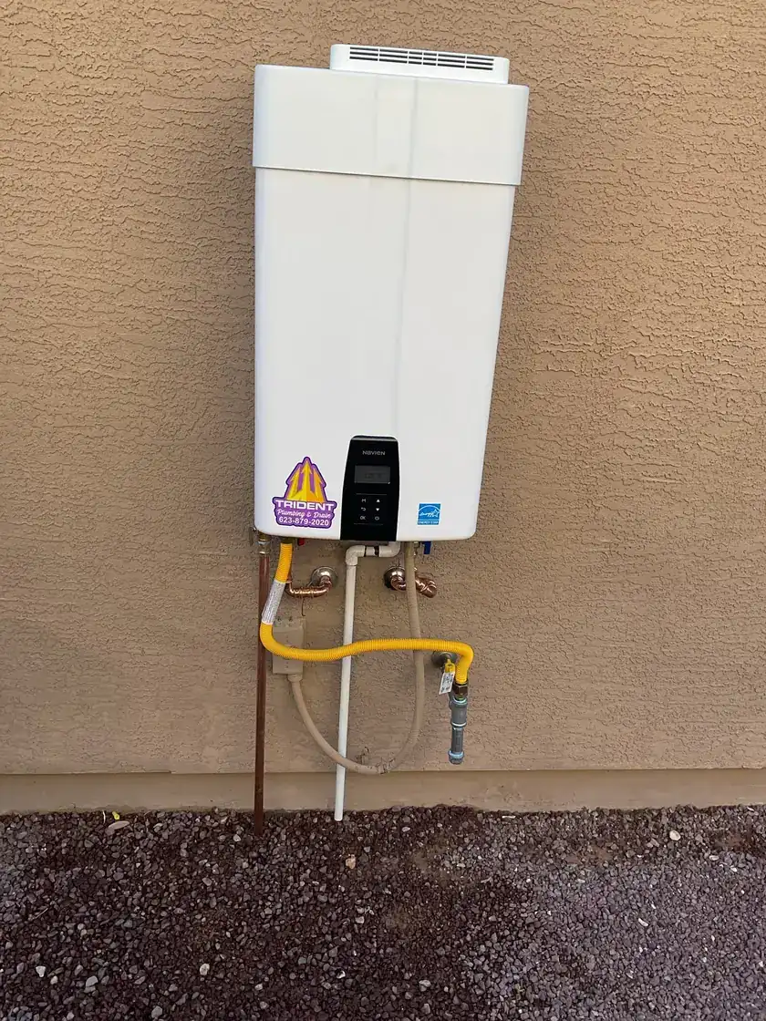 New tank water heater installed outdoors for reliable hot water in an Arizona home.