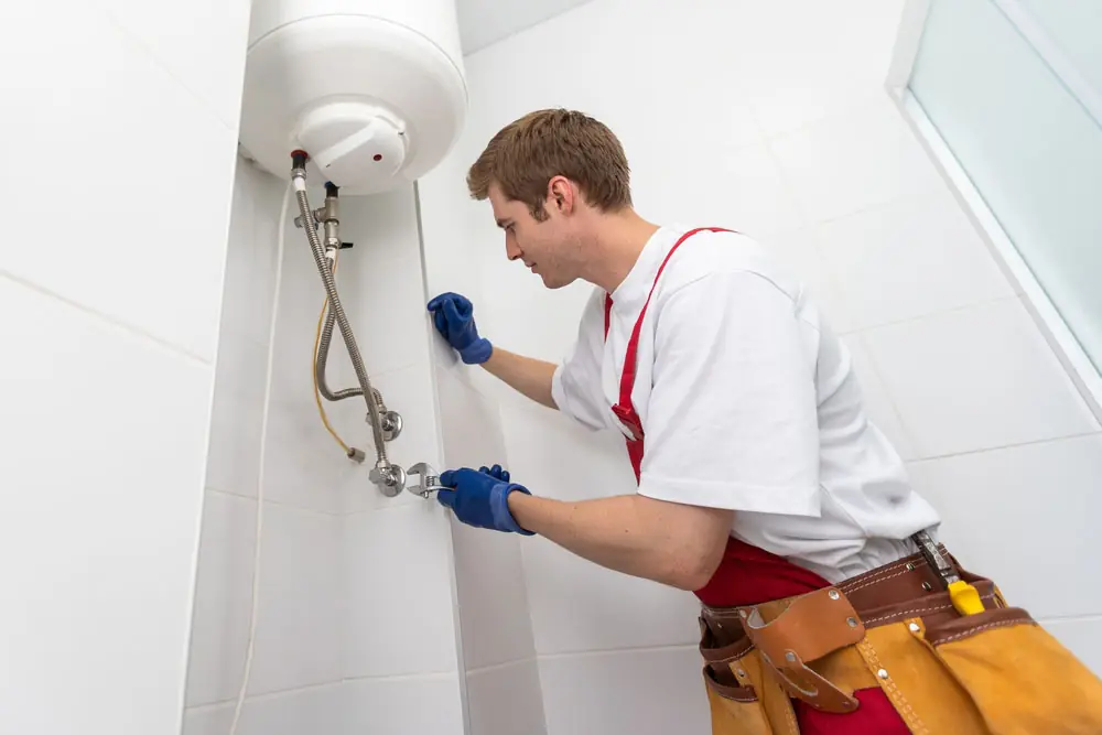 technician inspecting a water heater