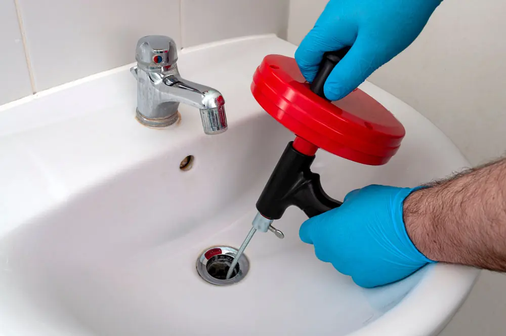 technician snaking a drain