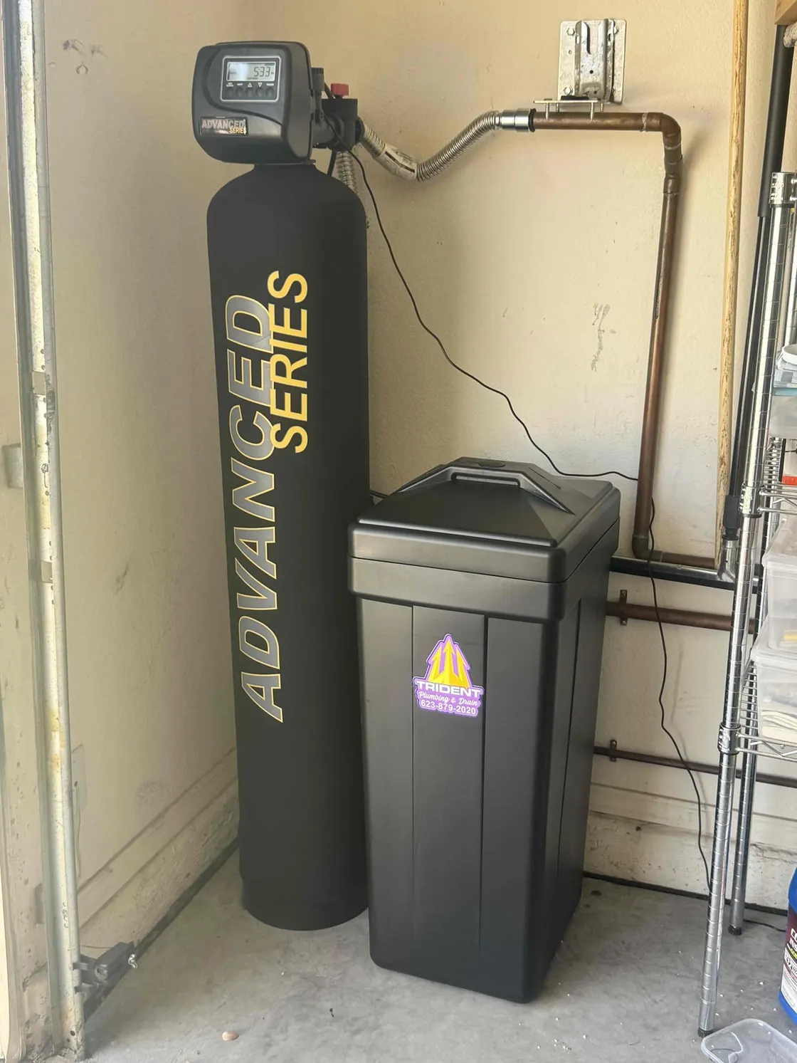 An Advantage water softener installed beside its brine tank