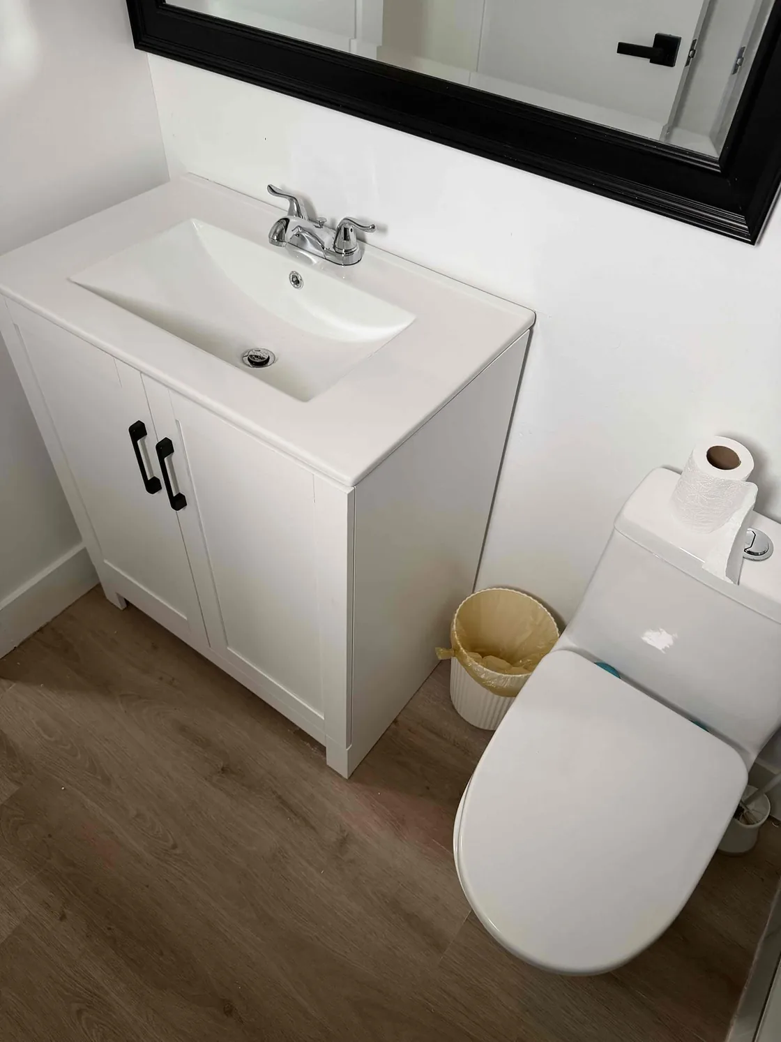 A finished bathroom vanity and white toilet