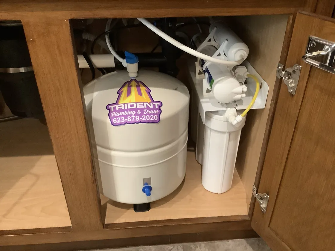 A reverse osmosis tank and filters installed beneath a sink