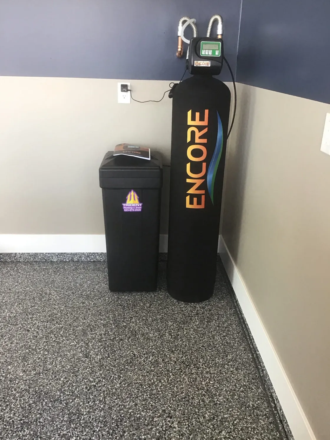 An Encore treatment tank and brine tank installed in a closet