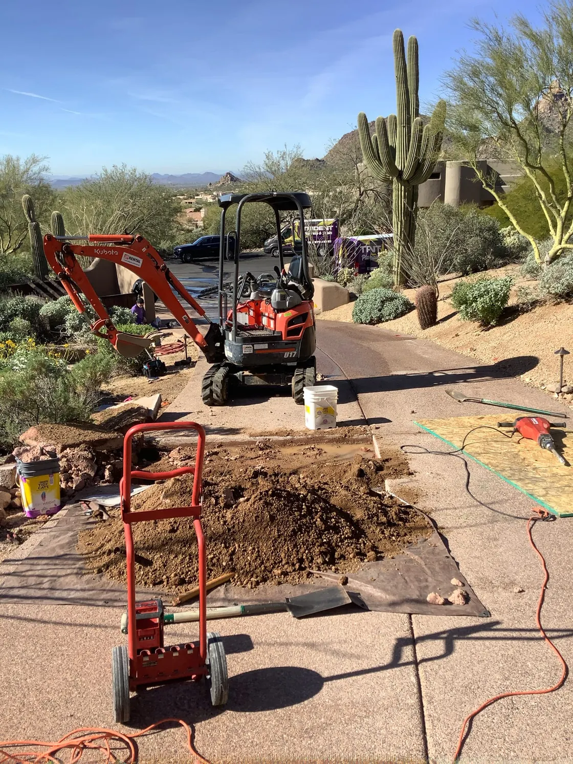 Excavation equipment and tools beside an opened plumbing work area