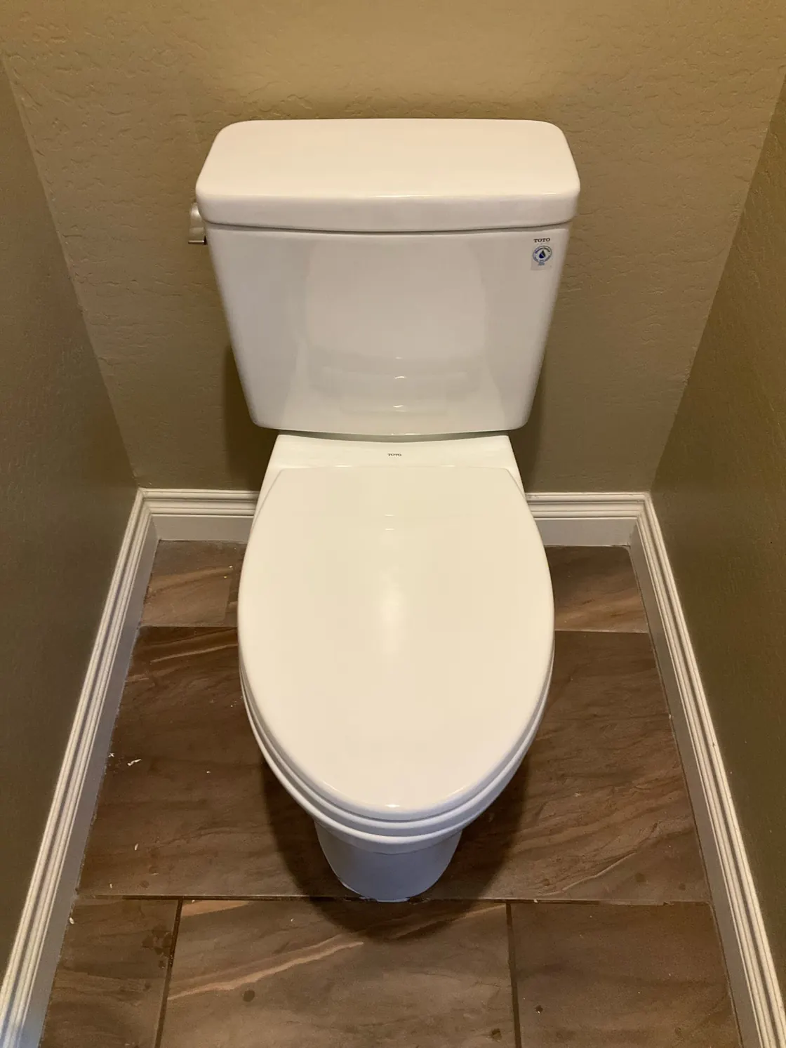 A TOTO toilet installed on a tiled bathroom floor