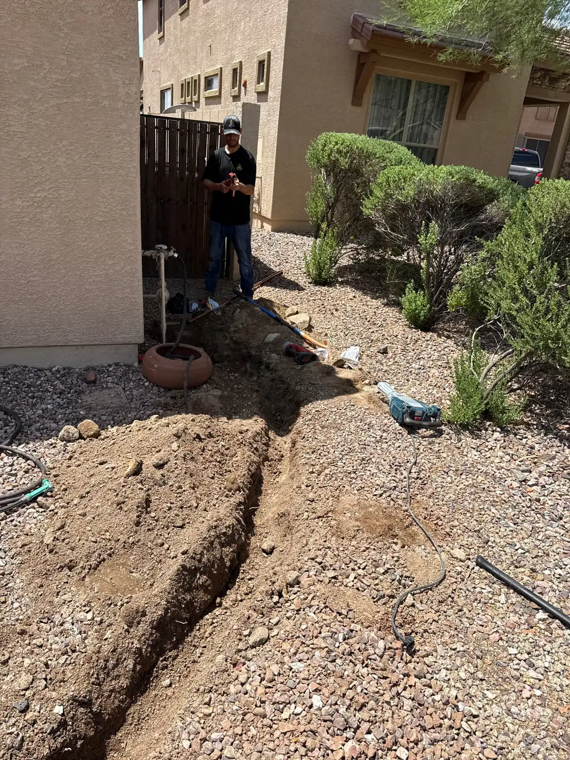 Excavation beside a home during water main repair work
