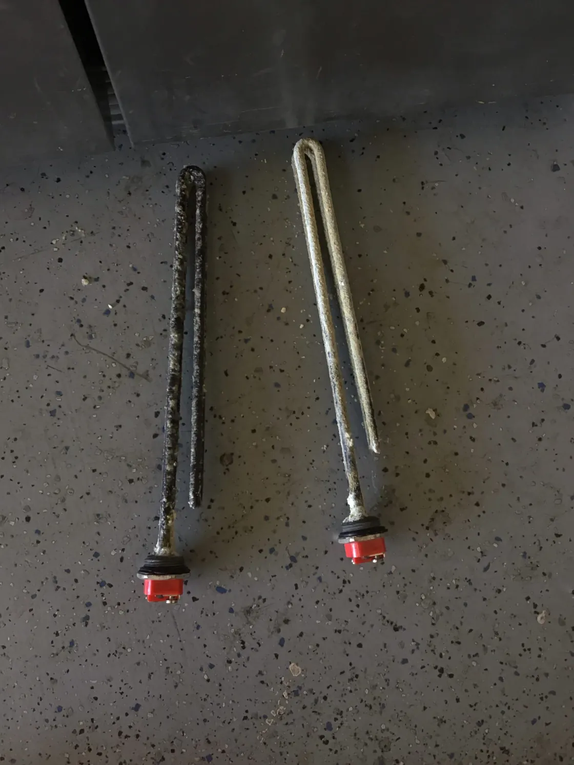 Removed water heater anode rods with visible wear