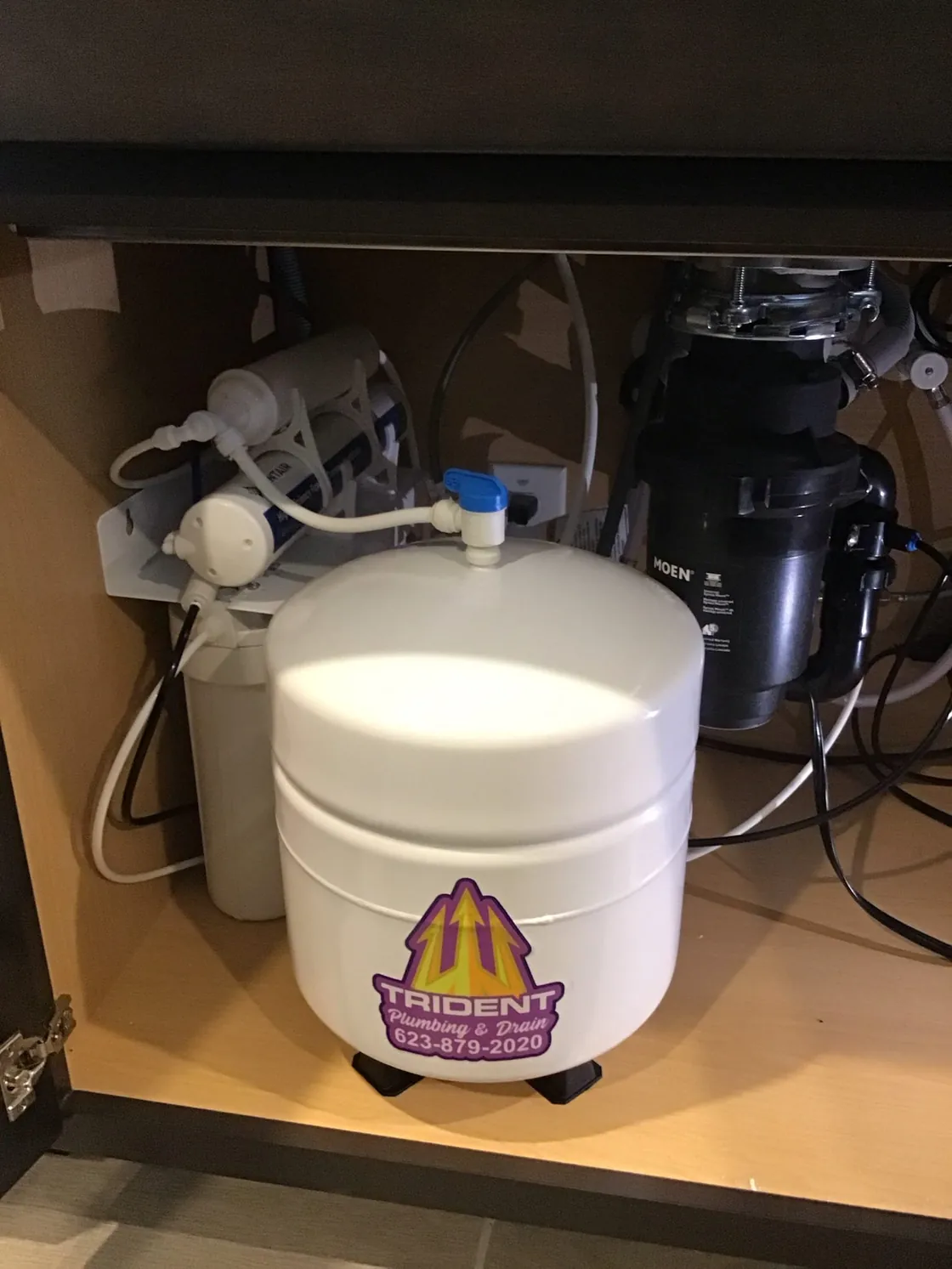 Reverse osmosis filters and storage tank connected beneath a sink
