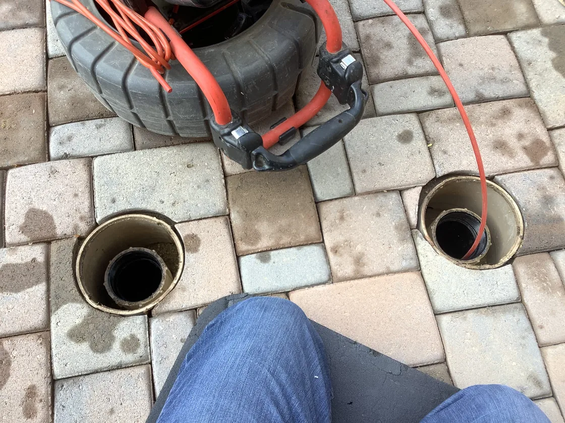 Sewer inspection equipment beside two open cleanouts