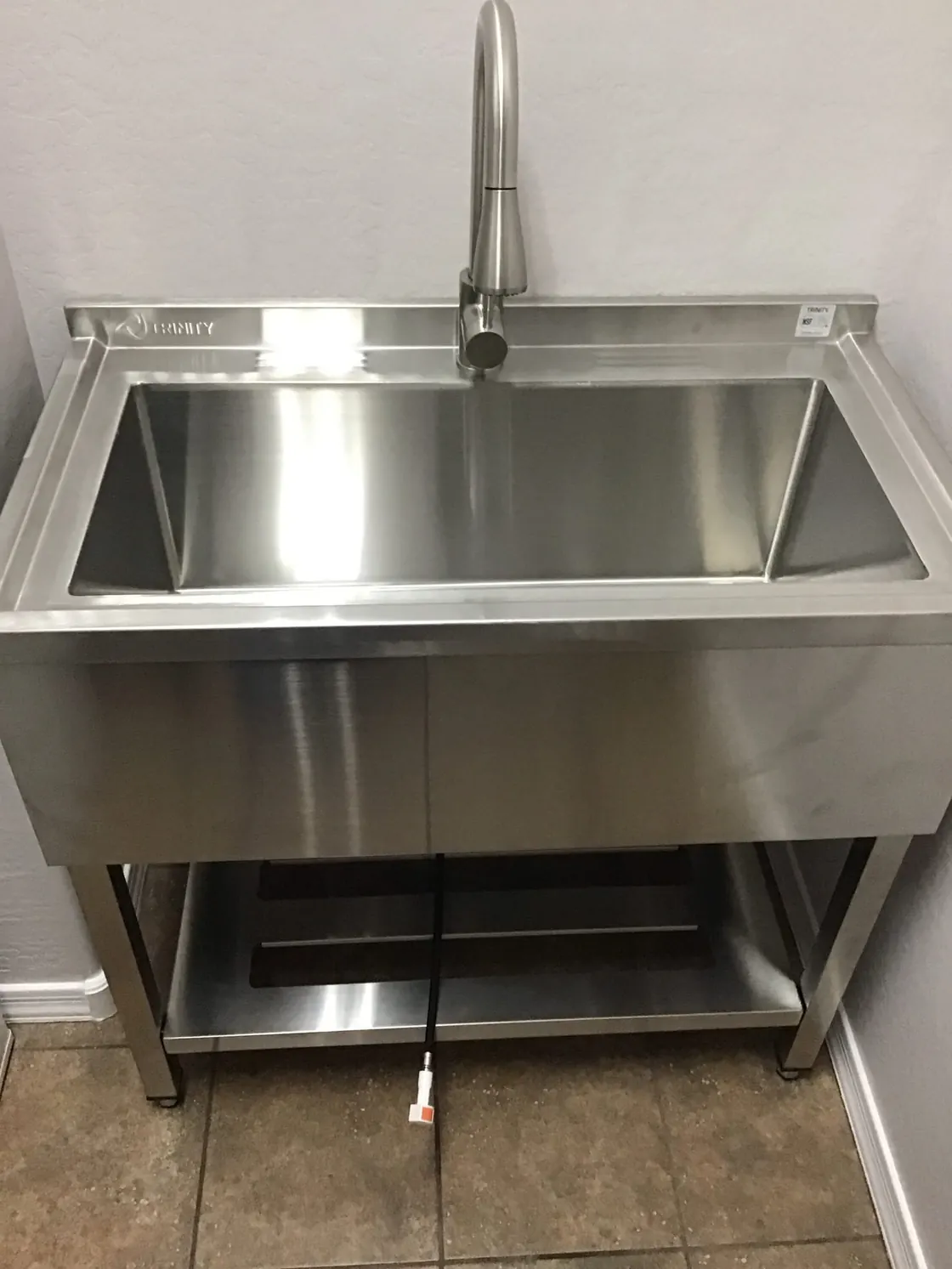 A stainless steel utility sink and its faucet