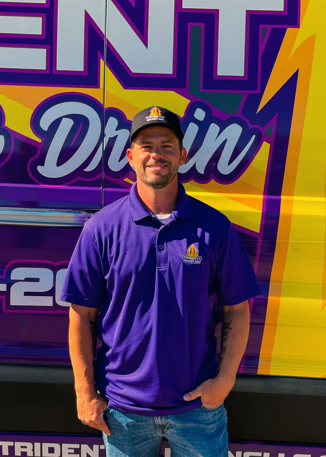 A Trident technician standing beside a branded service van