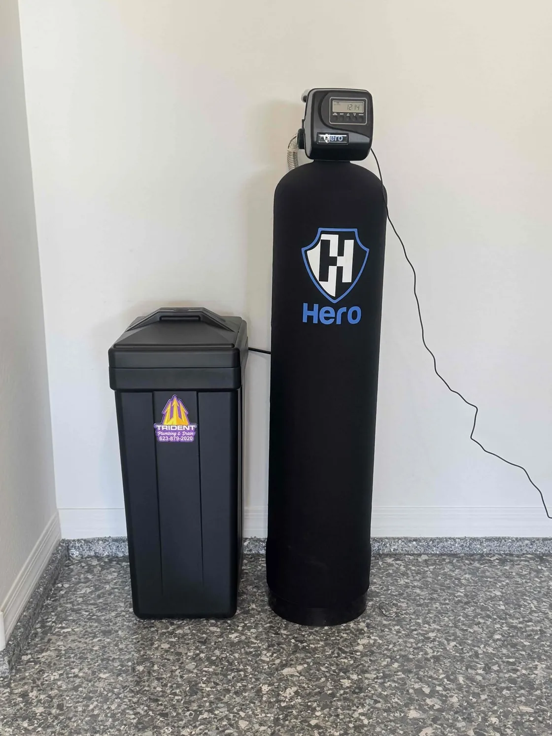 A Hero water treatment system installed beside its salt tank