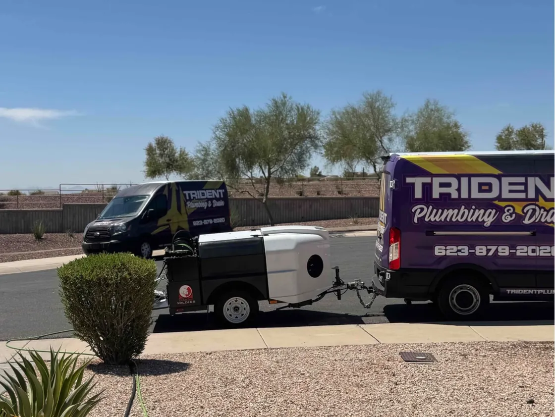 Trident service vans with a jetting trailer parked between them