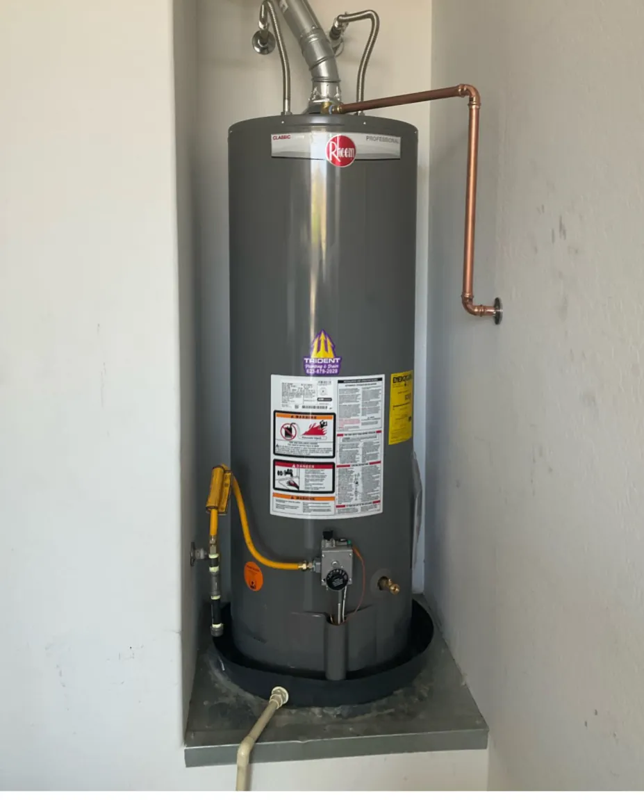 A water heater installed in a narrow utility closet