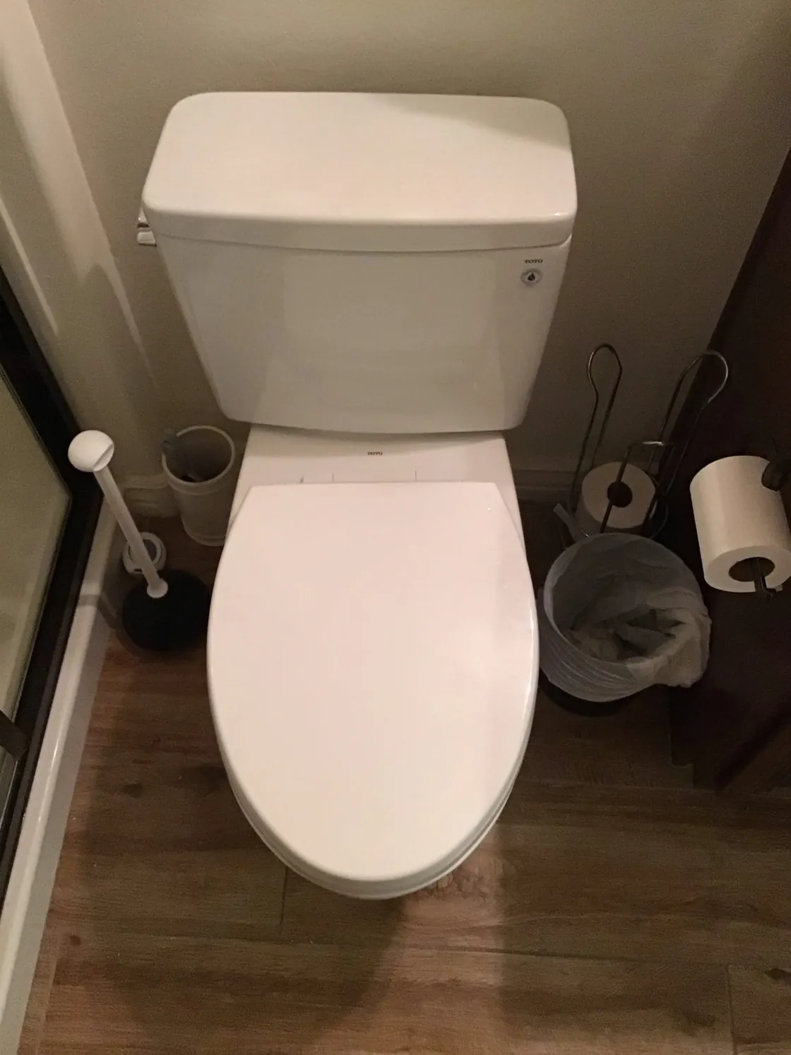 A white TOTO toilet installed in a bathroom