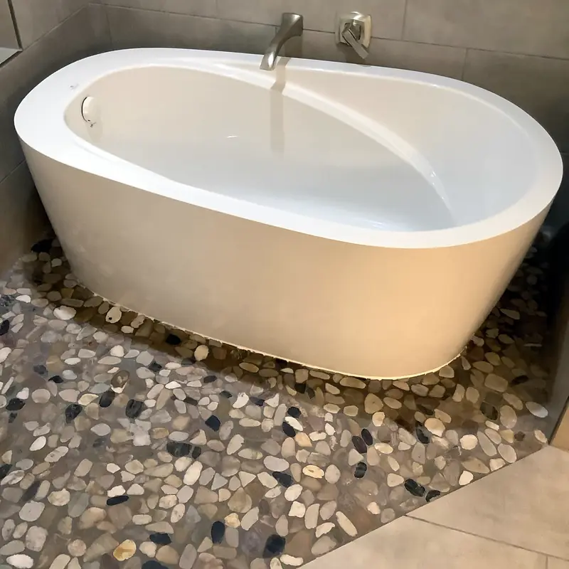 Freestanding bathtub with a floor-mounted tub filler