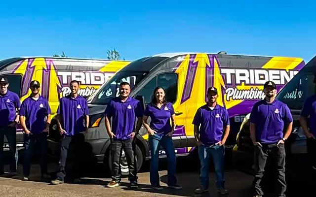 The Trident crew lined up in front of their wrapped service vans