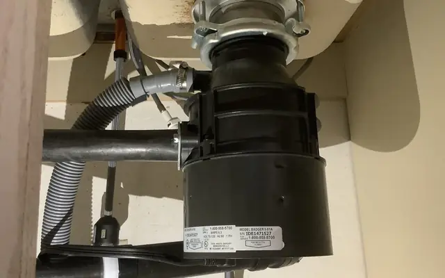 Garbage disposal unit installed under a kitchen sink