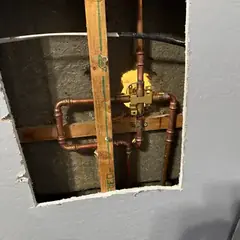 New shower valve plumbed in copper inside an opened wall
