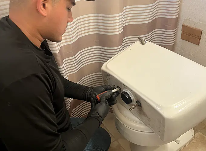 Ronnie working on toilet
