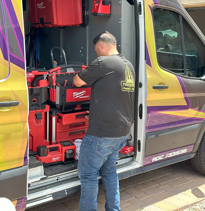 plumber arranging hydro jetting equipment