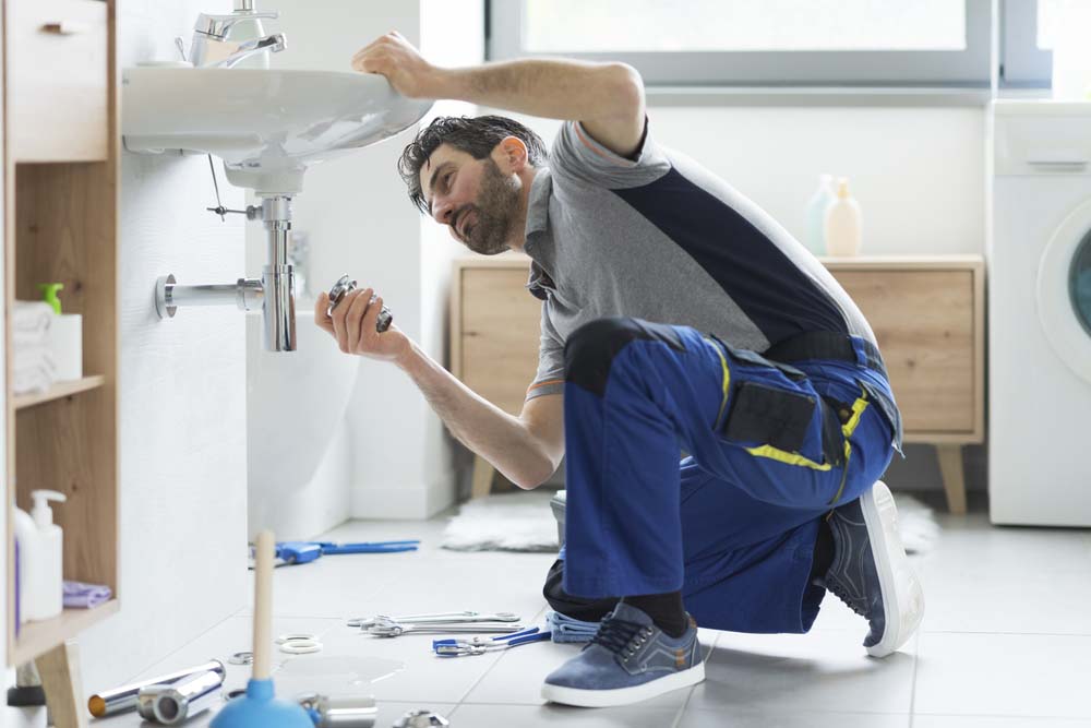 Plumber repairing a bathroom sink Scottsdale, AZ