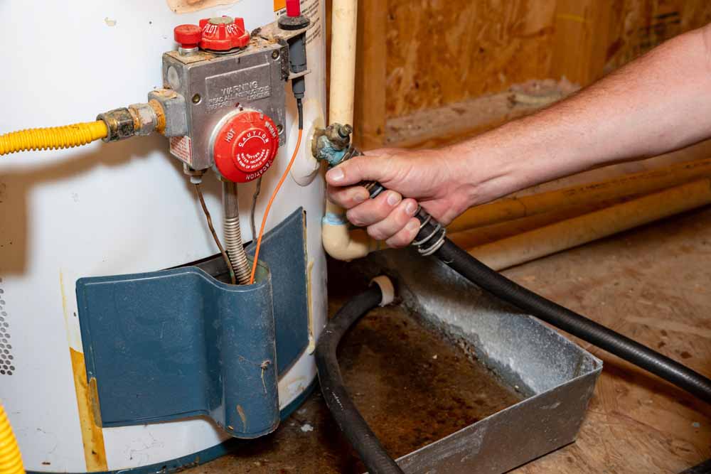 Trident technician flushing a water heater tank