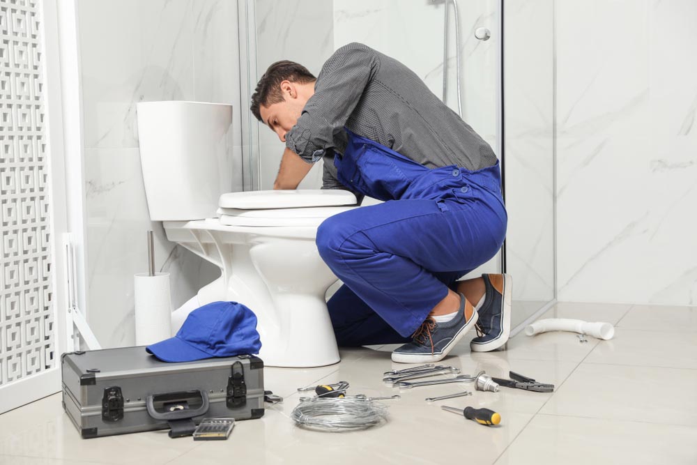 Trident technician working on toilet repairs