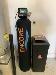 Whole-home combination water filtration and softening system installed in a Phoenix garage.