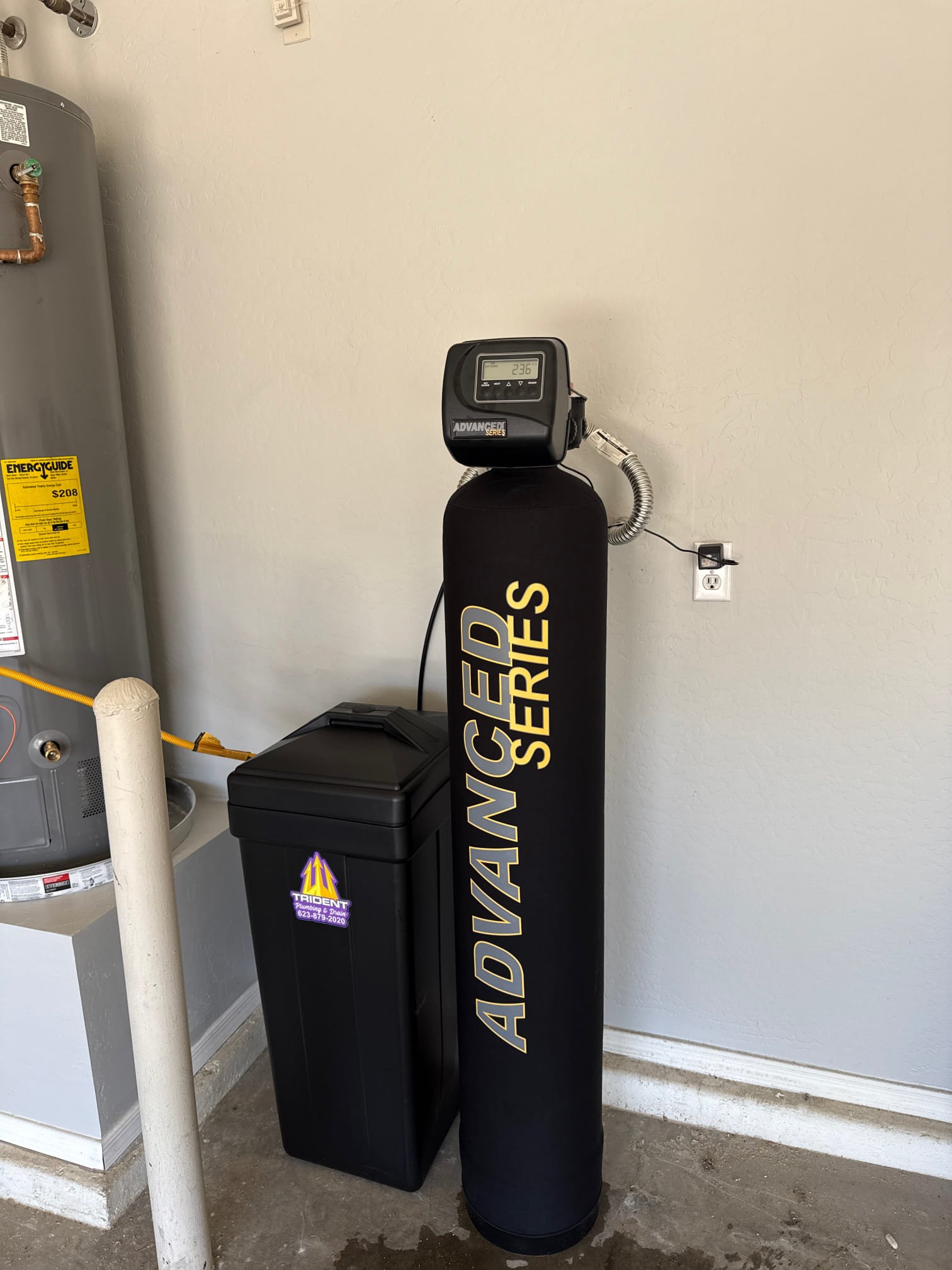 Professional installation of a whole home water softener system in a Phoenix garage.