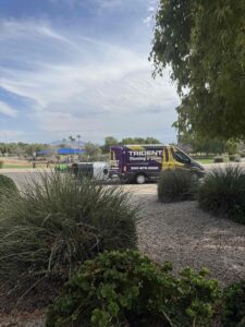 A Trident Plumbing service van parked in a residential driveway in front of a modern West Valley home.