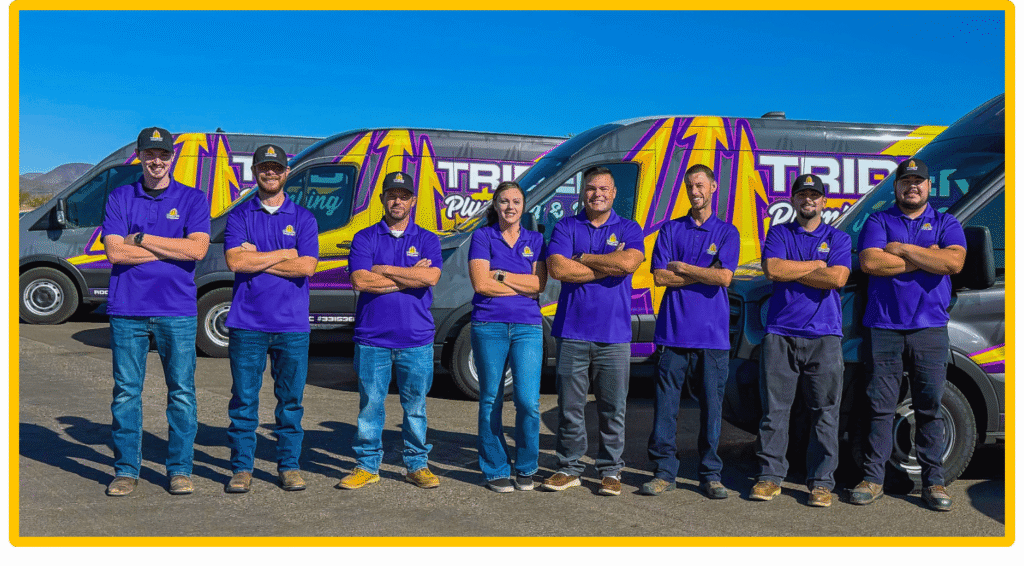Trident Plumbing & Drain Team Photo posing infront of work trucks