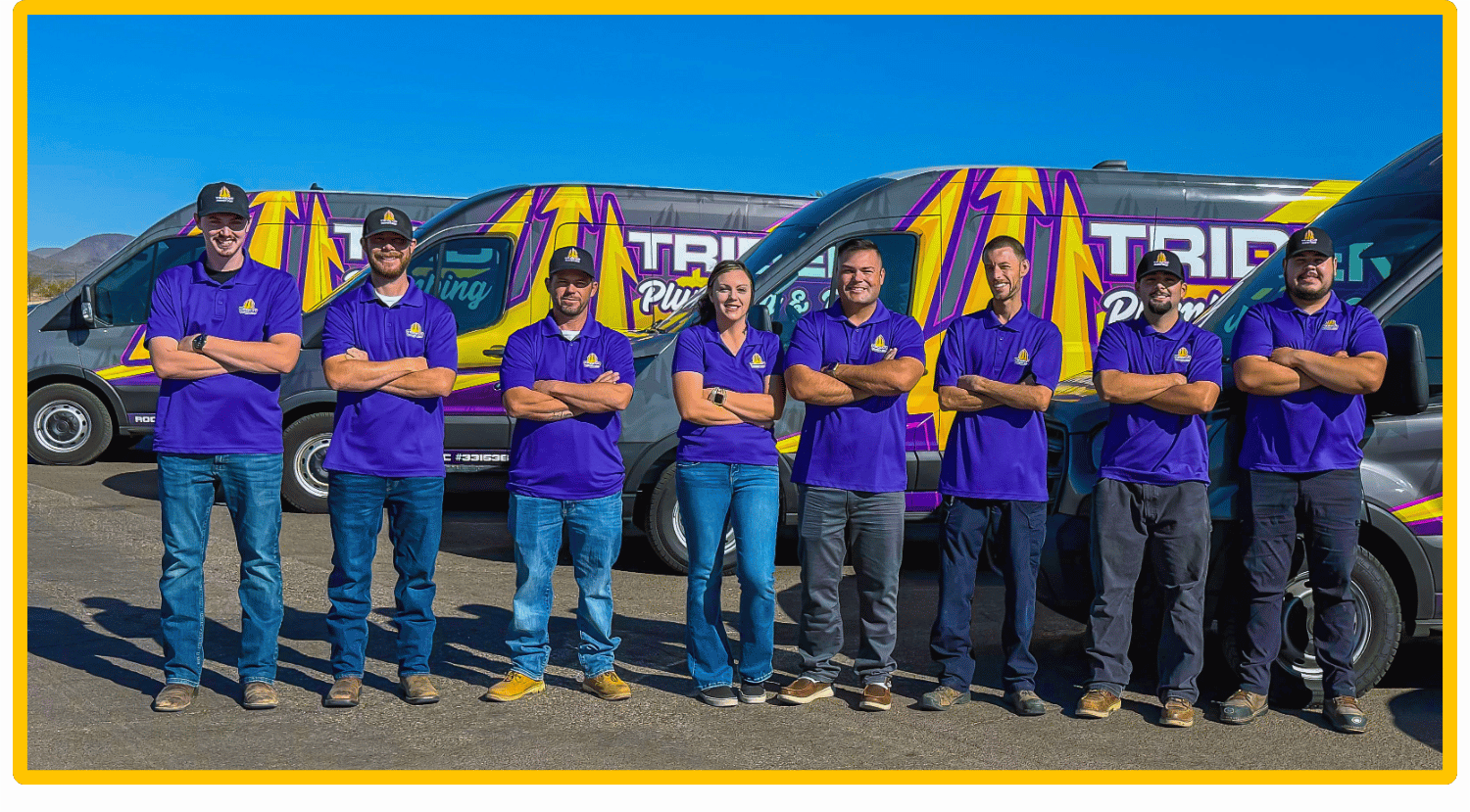 Trident Plumbing & Drain Team Photo posing infront of work trucks