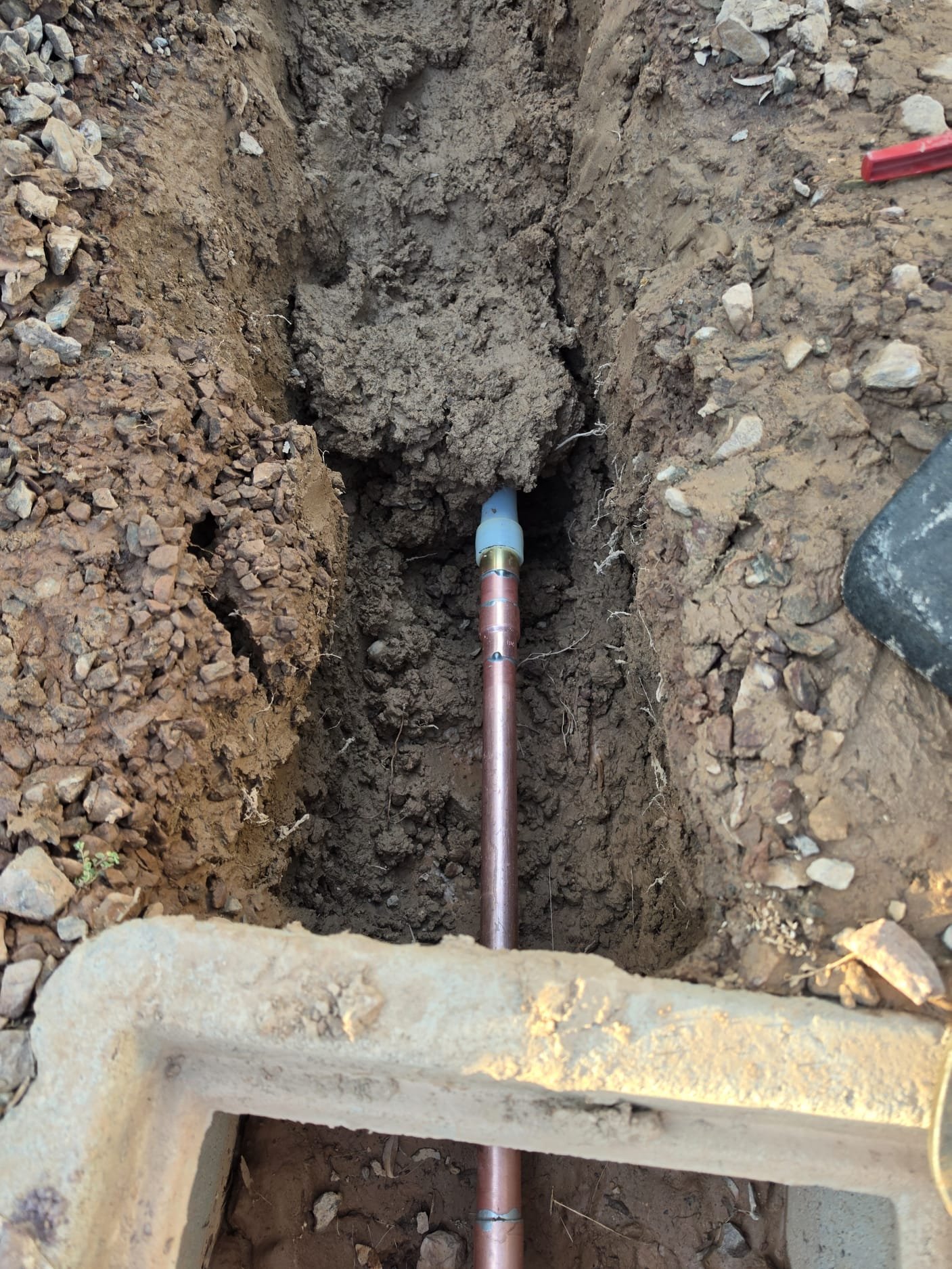 Main residential water line repair using new copper piping to restore reliable water service.
