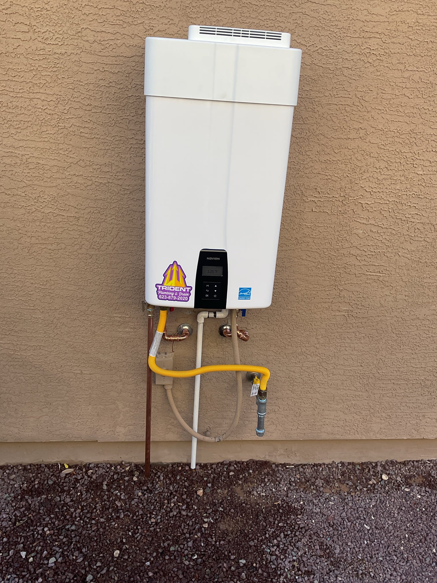 New tank water heater installed outdoors for reliable hot water in an Arizona home.