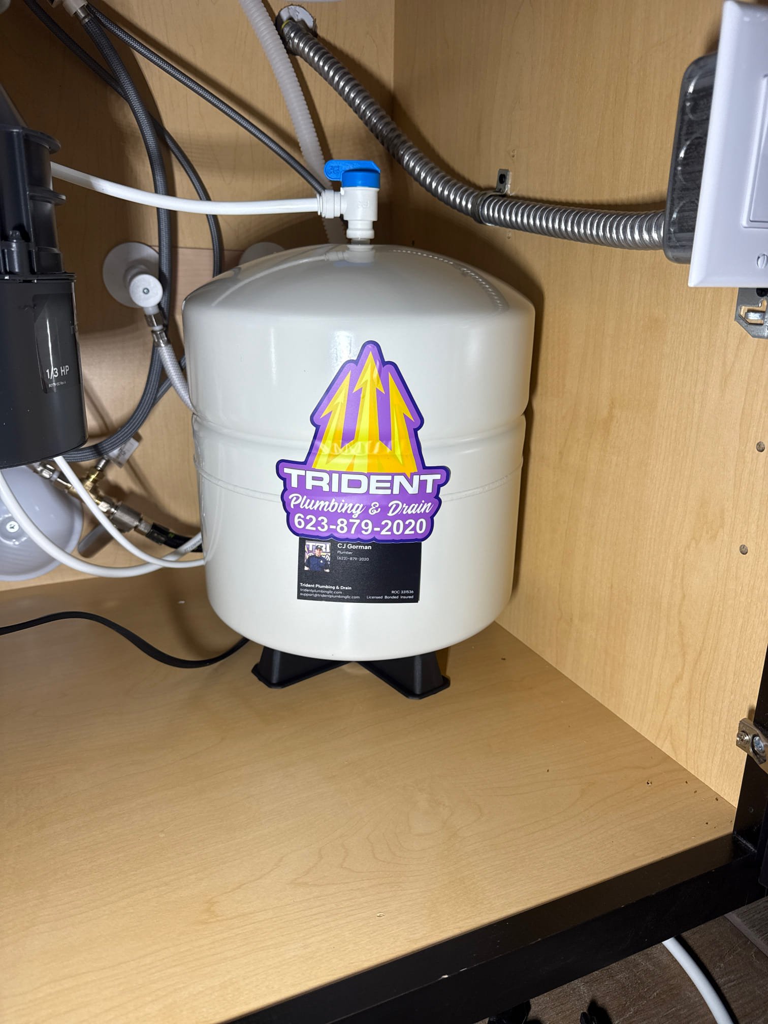 Residential reverse osmosis drinking water system installed beneath a kitchen sink.