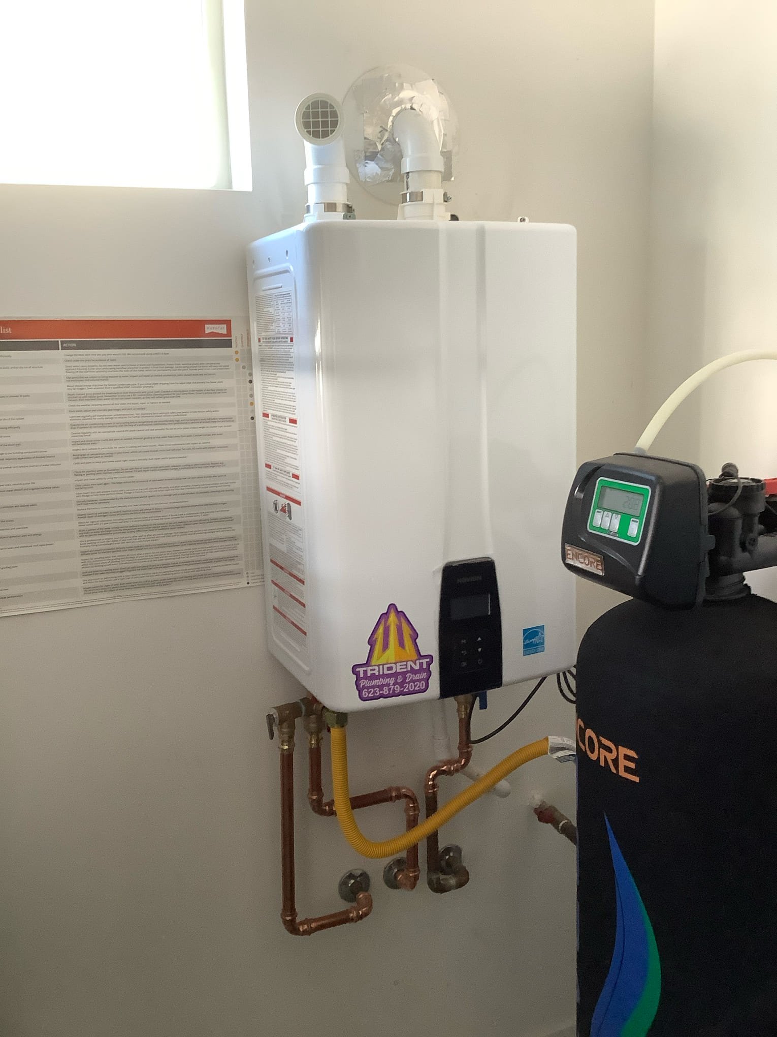 Tankless water heater professionally installed with a whole-home water softener to improve efficiency and reduce mineral buildup.