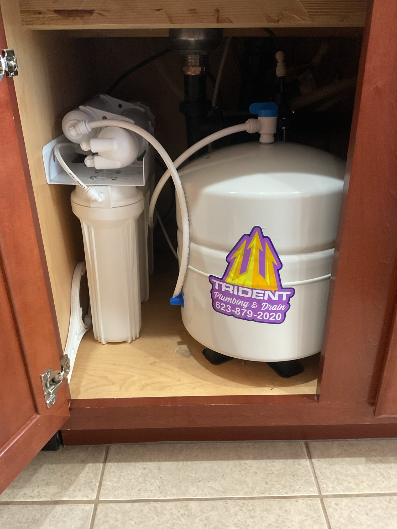 Under-sink reverse osmosis water filtration system installed for clean drinking water.