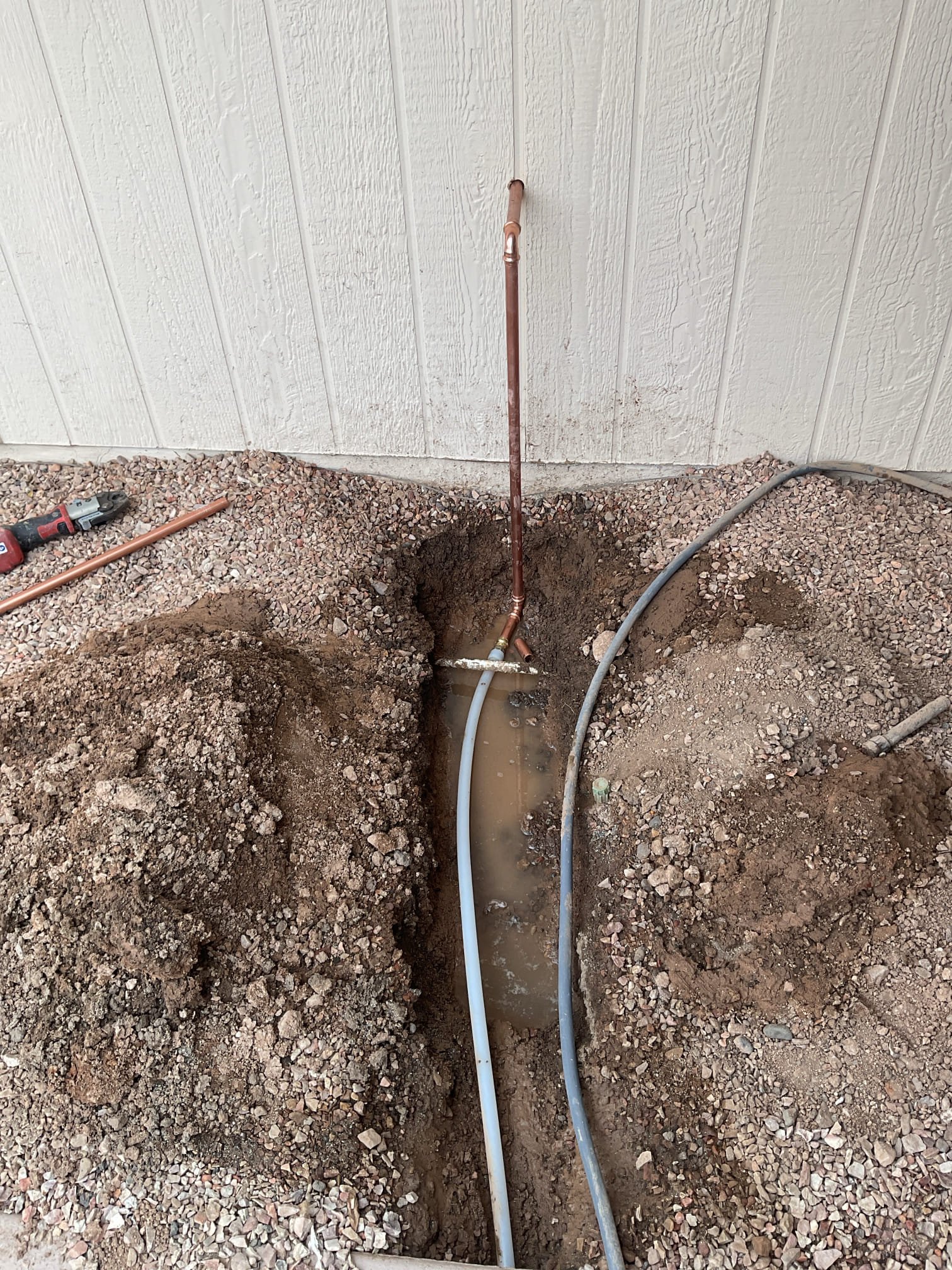 Exposed underground plumbing during hidden water leak diagnosis and pipe reroute in Arizona