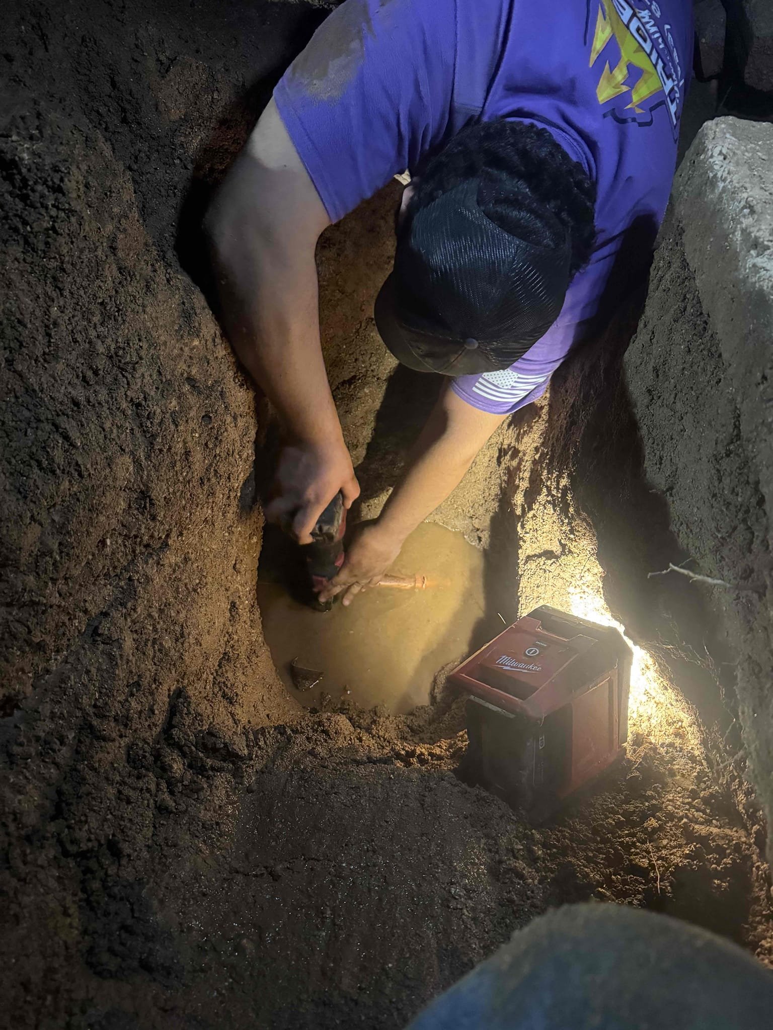 Trident Plumbing technician repairing a leaking water line during slab leak service in Arizona