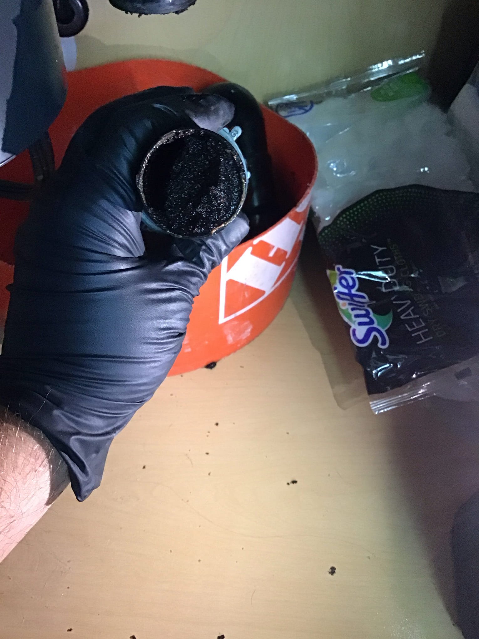 Coffee grounds and buildup clogging a kitchen drain pipe in a Phoenix AZ home