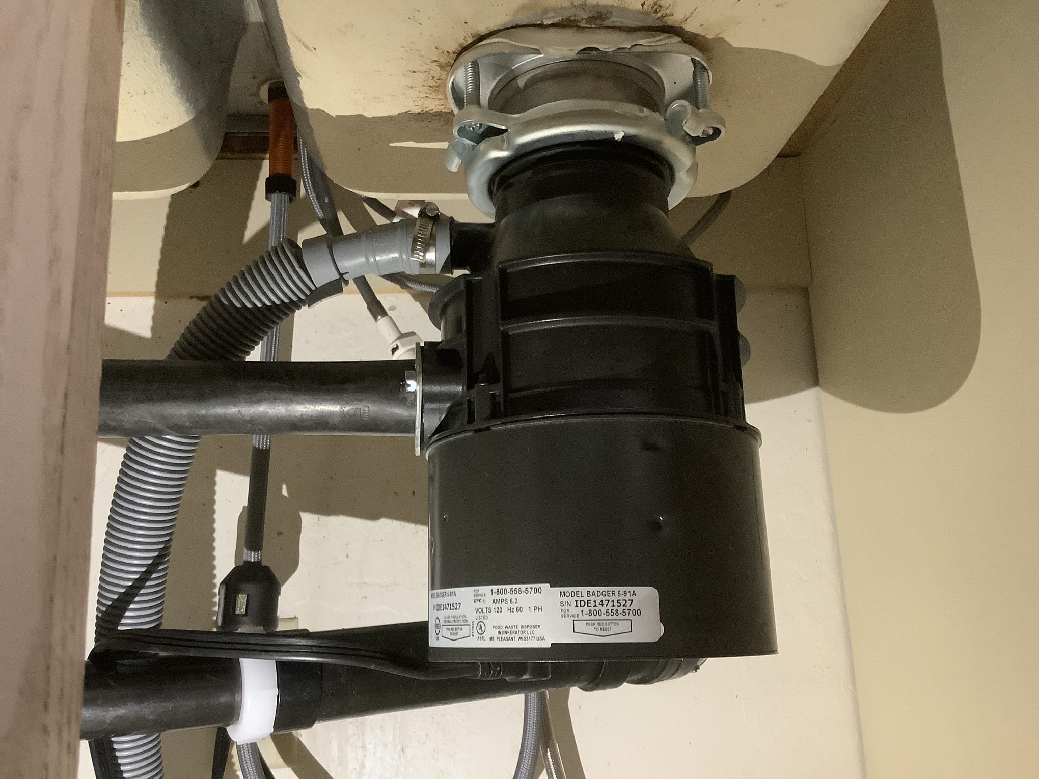 Garbage disposal installed under a kitchen sink in a Phoenix AZ home