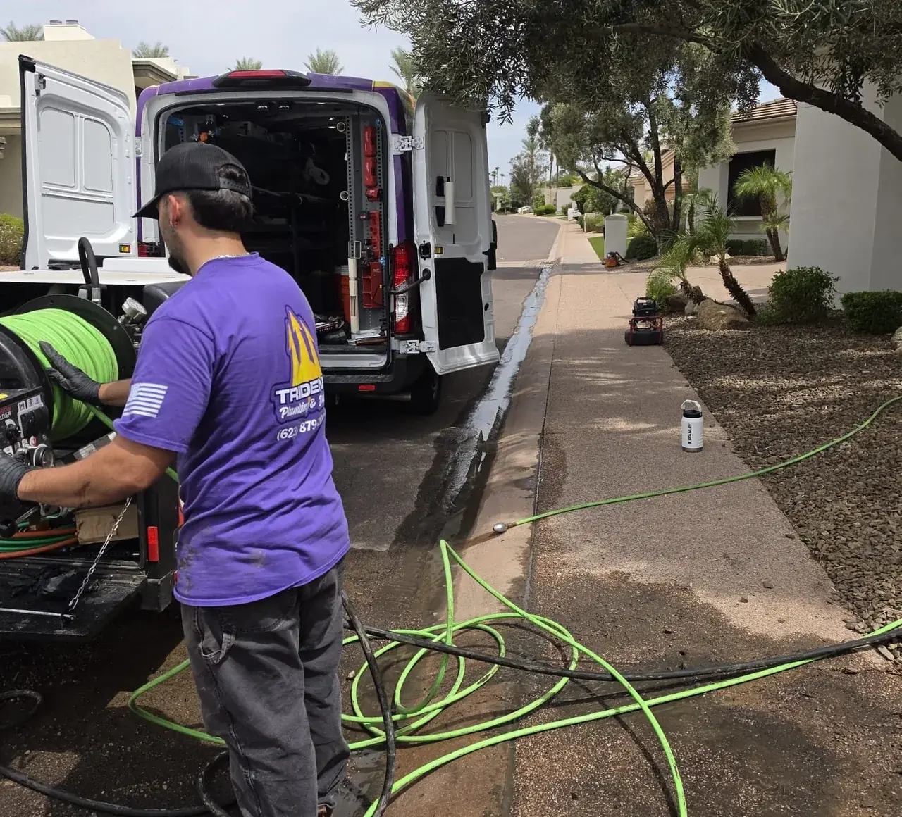 Trident Plumbing & Drain technician hydro jetting a residential sewer line in Glendale, AZ.