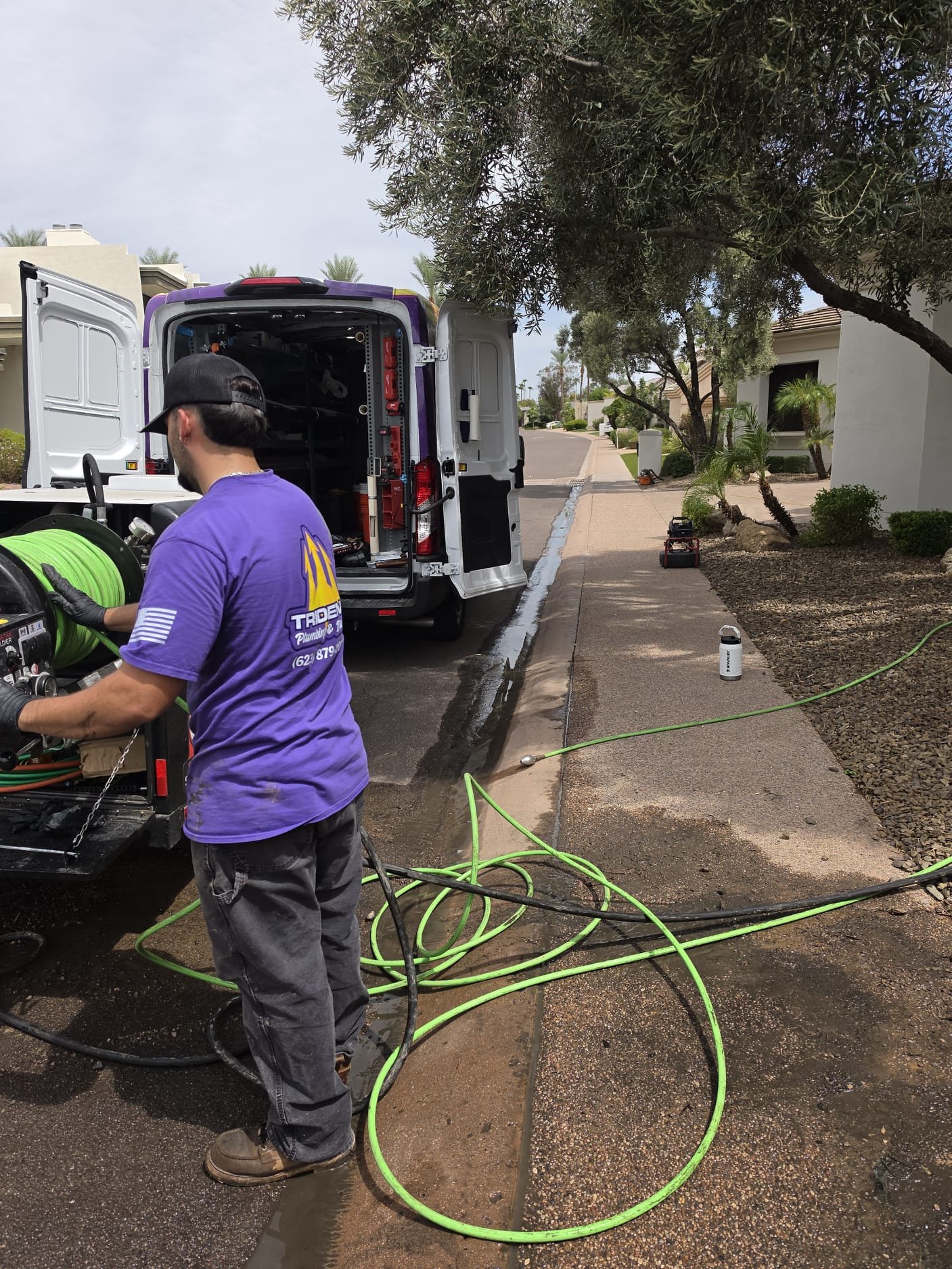 Plumber performing professional drain cleaning at an Arizona home