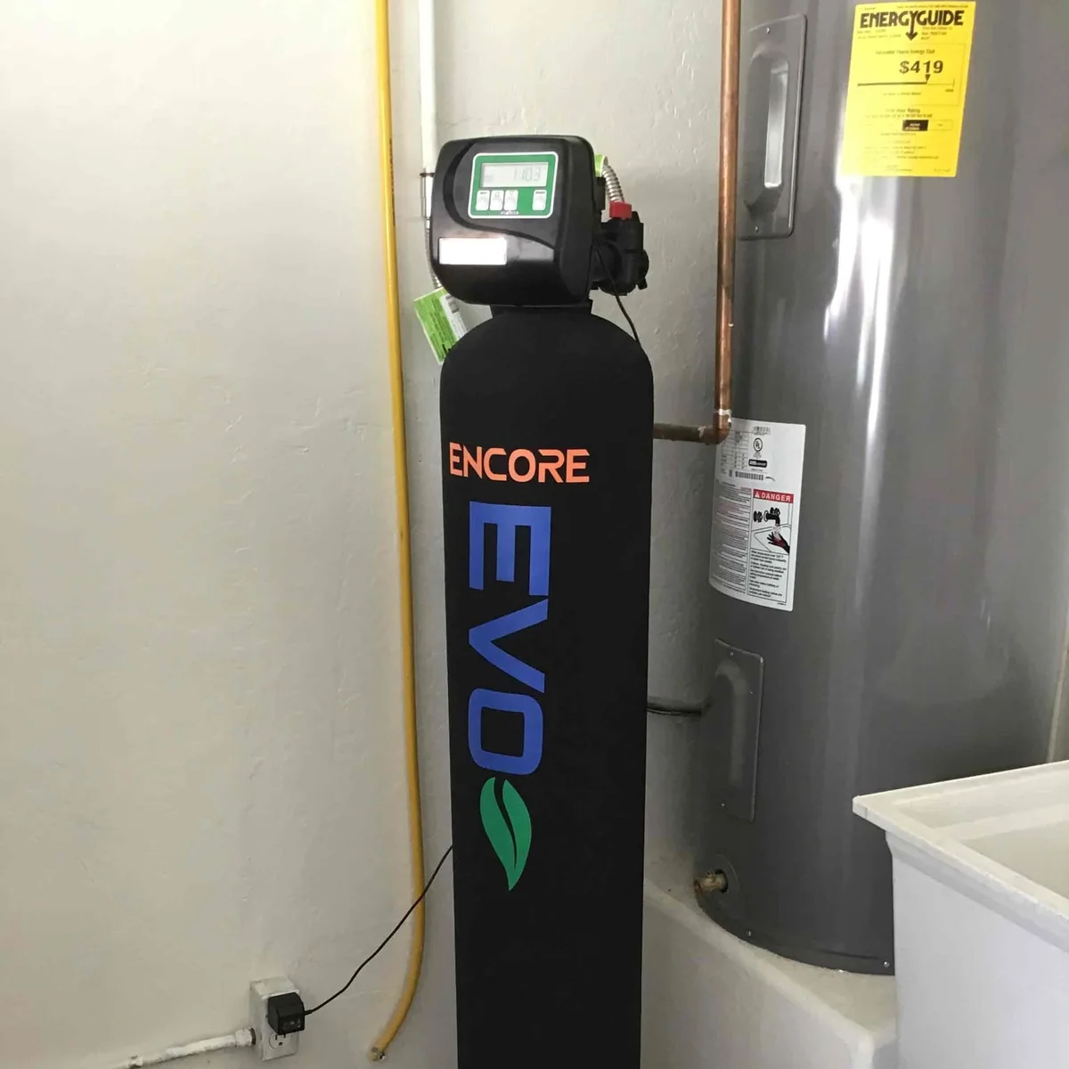 Encore EVO salt-free water conditioning system installed beside a water heater in Litchfield Park, AZ.