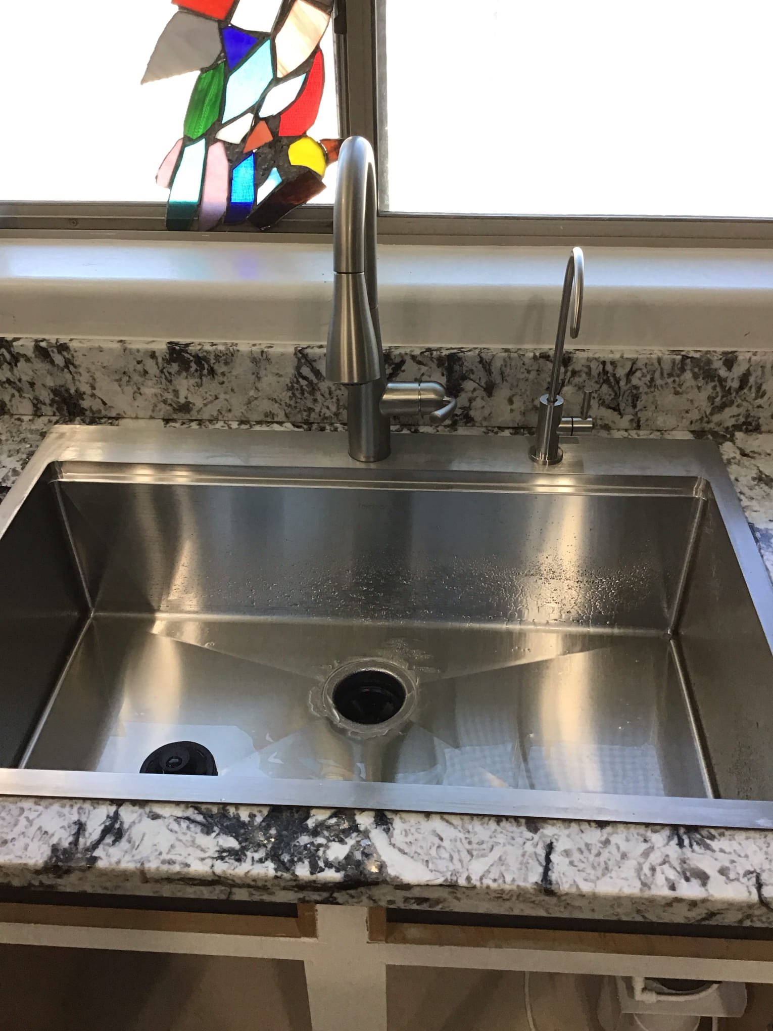 Slow kitchen sink drain with standing water in an Arizona home