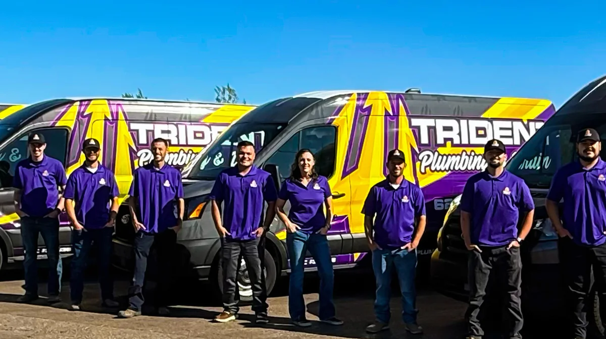 The Trident Plumbing & Drain team standing in front of their service vans in Phoenix, AZ.